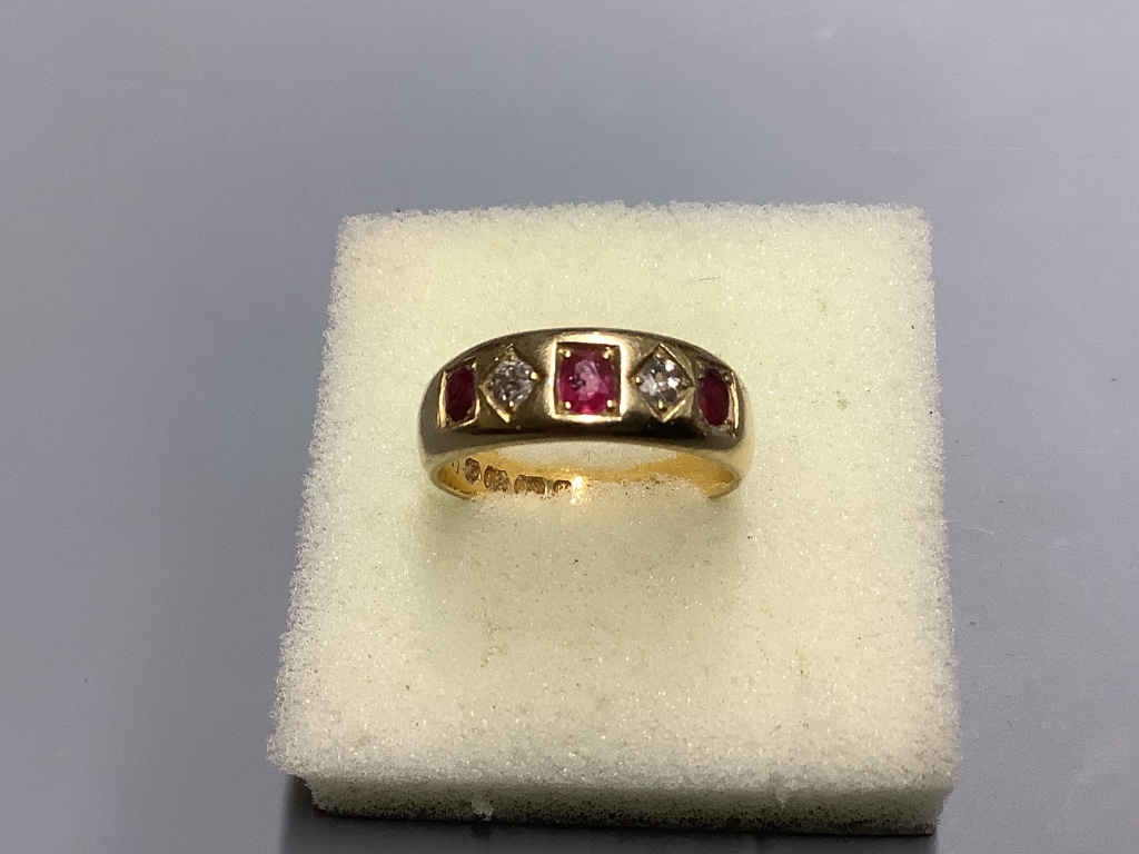 A late Victorian 18ct gold and gypsy set three stone ruby and two stone diamond half hoop ring